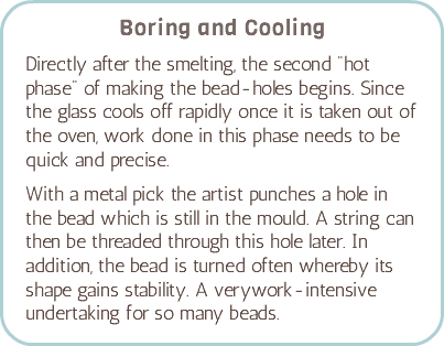 Boring and Cooling Directly after the smelting, the second "hot phase" of making the bead-holes begins. Since the glass cools off rapidly once it is taken out of the oven, work done in this phase needs to be quick and precise. With a metal pick the artist punches a hole in the bead which is still in the mould. A string can then be threaded through this hole later. In addition, the bead is turned often whereby its shape gains stability. A verywork-intensive undertaking for so many beads.